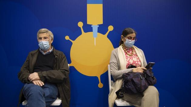 People rest after receiving coronavirus vaccines at a Covid-19 vaccination center in Tel Aviv, Israel.(AP)