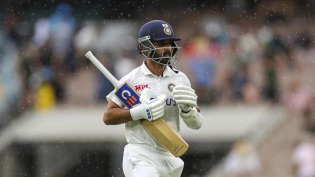 India's Ajinkya Rahane walks from the field as the rain starts during play on day two of the second cricket test between India and Australia at the Melbourne Cricket Ground.(AP)