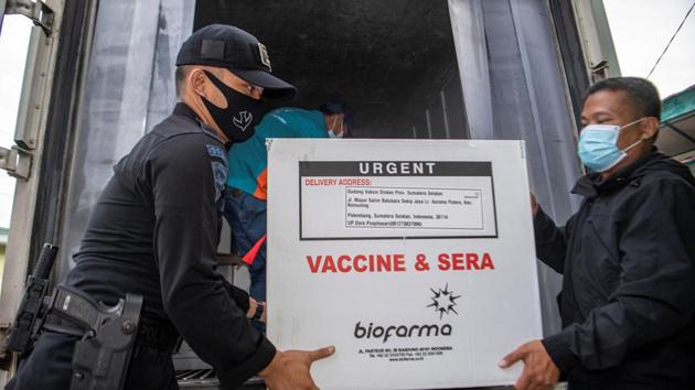 Officers offload a box of Sinovac's vaccine for coronavirus disease (COVID-19) as it arrives at the cold room of Indonesia's local health department in Palembang, South Sumatra province, Indonesia, January 4, 2021 in this photo taken by Antara Foto. Antara Foto/Nova Wahyudi/ via REUTERS