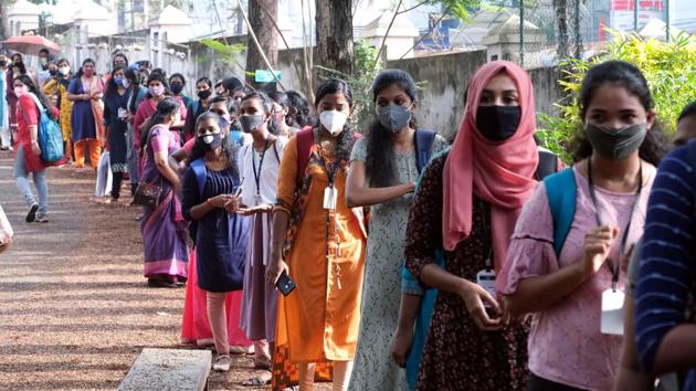 Students stand in a queue at Women's college in Thiruvananthapuram as it reopened on Monday. (ANI Photo) Students stand in a queue at Women's college in Thiruvananthapuram as it reopened on Monday. (ANI Photo)