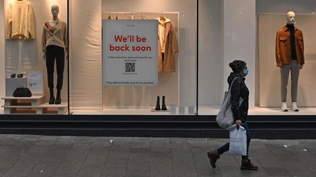 A pedestrian wearing a face mask walks past a shuttered H&M store in Liverpool on January 5. Under new guidelines, expected in place till mid-February, non-essential shops and hospitality will remain closed, while primary and secondary schools would close from January 5 for all pupils except vulnerable children and those whose parents are key workers, Reuters reported. (Paul Ellis / AFP) A pedestrian wearing a face mask walks past a shuttered H&M store in Liverpool on January 5. Under new guidelines, expected in place till mid-February, non-essential shops and hospitality will remain closed, while primary and secondary schools would close from January 5 for all pupils except vulnerable children and those whose parents are key workers, Reuters reported. (Paul Ellis / AFP)