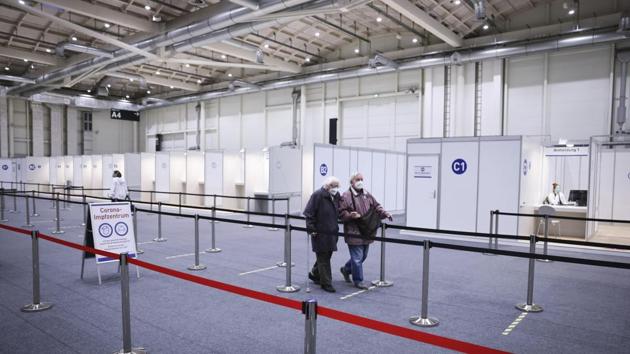 Two seniors walk through the Immunization Center at the Exhibition Halls for their vaccination in Hamburg, Germany. (AP) Two seniors walk through the Immunization Center at the Exhibition Halls for their vaccination in Hamburg, Germany. (AP)
