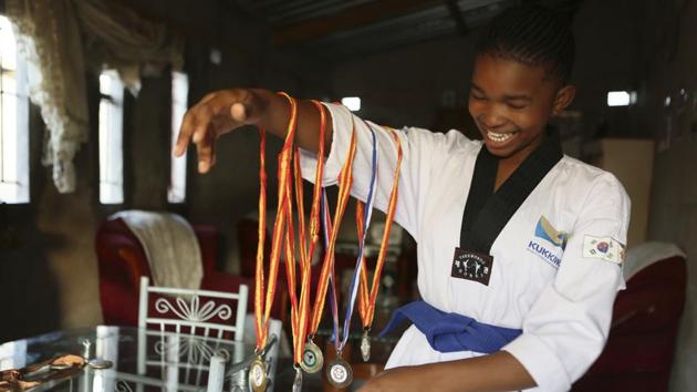 Natsiraishe Maritsa shows some of her taekwondo medals at her home in the Epworth settlement about 15 km southeast of the capital Harare. In Zimbabwe, where girls as young as 10 are forced to marry due to poverty or traditional and religious practices, a teenage martial arts fan 17-year old Natsiraishe Maritsa is using the sport to give girls in an impoverished community a fighting chance at life.(AP)