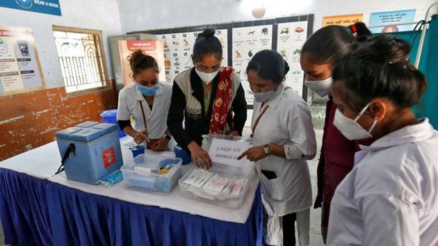 Healthcare workers prepare a vaccination room inside a classroom of a school, which was converted into a temporary Covid-19 vaccination centre in Ahmedabad, on January 4.(Reuters Photo) Healthcare workers prepare a vaccination room inside a classroom of a school, which was converted into a temporary Covid-19 vaccination centre in Ahmedabad, on January 4.(Reuters Photo)