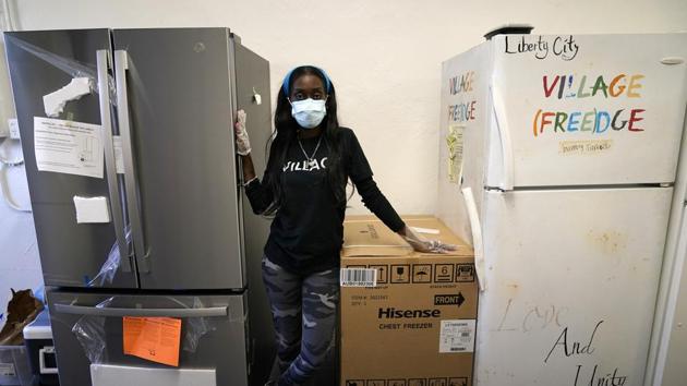 Sherina Jones poses with a new community refrigerator she received with donations from friends, in the Liberty City neighborhood of Miami. Jones offers free food for the community from a stocked community refrigerator called the Village Freedge. When one of the refrigerators was stolen just before Thanksgiving, the community and friends came together to help purchase a new one. Jones also provides hot food and distributes numerous food pantry items. She has applied for non-profit status and is transitioning to become a food bank.(AP) Sherina Jones poses with a new community refrigerator she received with donations from friends, in the Liberty City neighborhood of Miami. Jones offers free food for the community from a stocked community refrigerator called the Village Freedge. When one of the refrigerators was stolen just before Thanksgiving, the community and friends came together to help purchase a new one. Jones also provides hot food and distributes numerous food pantry items. She has applied for non-profit status and is transitioning to become a food bank.(AP)