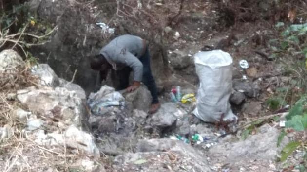 The image shows an individual cleaning the area around the waterfall. (Twitter/@iPradeepSangwan) The image shows an individual cleaning the area around the waterfall. (Twitter/@iPradeepSangwan)