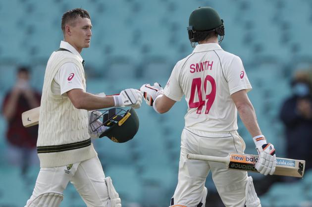 Australia's Steve Smith and Marnus Labuschagne, left, walk from the field following play on day one of the third cricket test between India and Australia at the Sydney Cricket Ground, Sydney, Australia, Thursday, Jan. 7, 2021. (AP Photo/Rick Rycroft) (AP)