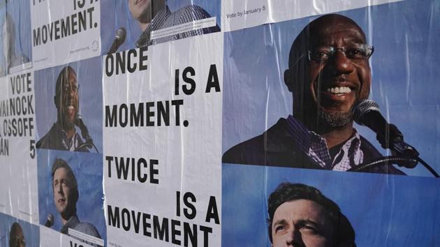 Campaign ads for Jon Ossoff and Raphael Warnock are seen on a wall near the John Lewis mural the day after the US Senate runoff elections in Atlanta, Georgia.(REUTERS) Campaign ads for Jon Ossoff and Raphael Warnock are seen on a wall near the John Lewis mural the day after the US Senate runoff elections in Atlanta, Georgia.(REUTERS)
