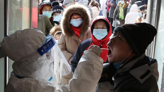 A medical worker in protective suit collects a swab from a resident during a mass nucleic acid testing following a recent coronavirus disease (COVID-19) outbreak in Shijiazhuang, Hebei province, China.(REUTERS)