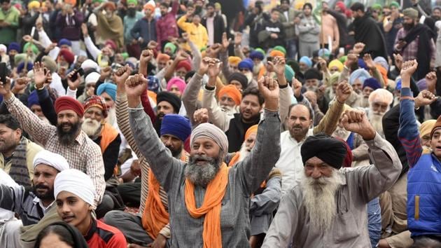 Farmers raising slogans during their protest at Singhu border on January 6. Farmers, primarily from Punjab and Haryana, have been camping at several Delhi border points since November 28, demanding repeal of the laws, and a legal guarantee on minimum support prices for their crops, among other issues. (Biplov Bhuyan / HT Photo) 