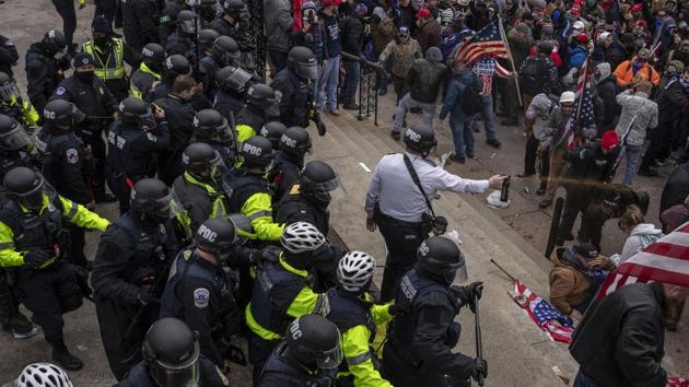 Pepper spray is used against demonstrators as they breach the US Capital building grounds in Washington.(Bloomberg) Pepper spray is used against demonstrators as they breach the US Capital building grounds in Washington.(Bloomberg)