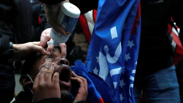 A protester is treated after getting pepper sprayed during clashes with Capitol police in Washington on January 6. The chaos unfolded after Trump addressed thousands of supporters near the White House and told them to march on the Capitol to express their anger at the voting process. (Shannon Stapleton / REUTERS) A protester is treated after getting pepper sprayed during clashes with Capitol police in Washington on January 6. The chaos unfolded after Trump addressed thousands of supporters near the White House and told them to march on the Capitol to express their anger at the voting process. (Shannon Stapleton / REUTERS)