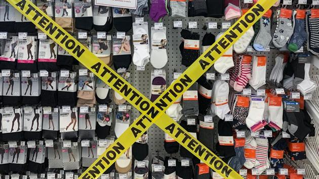 Tape is shown covering non-essential products that can't be sold at a pharmacy in Montreal, Quebec, Canada.(AP)