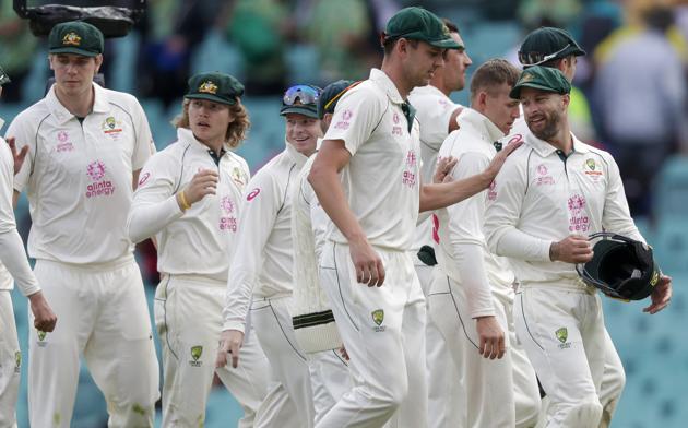 Australian players walk from the field at the end of play on day two of the third cricket test between India and Australia at the Sydney Cricket Ground, Sydney, Australia, Friday, Jan. 8, 2021. (AP Photo/Rick Rycroft) (AP)