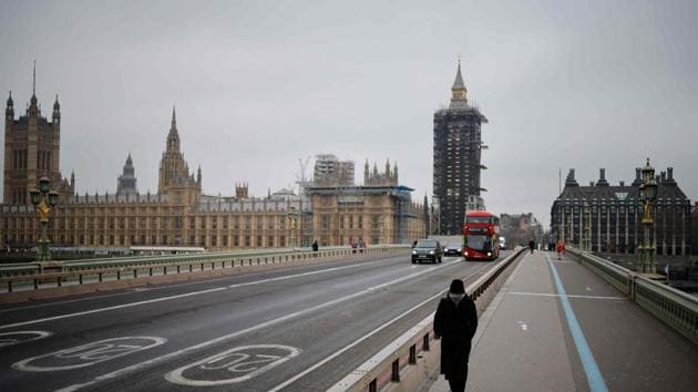 A pedestrian walks across a near-deserted Westminster Bridge in central London on January 8.(AFP)