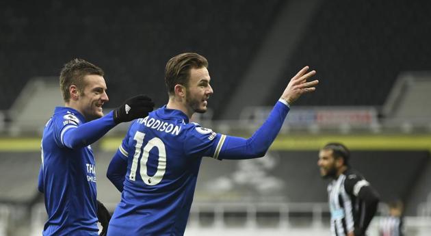 Leicester's James Maddison, centre, celebrates with Jamie Vardy after scoring his side's opening goal during the English Premier League soccer match between Newcastle United and Leicester City at St. James' Park in Newcastle.(AP)