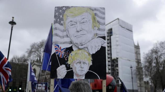 In this Jan. 8, 2020 file photo remain in the European Union, anti-Brexit protesters, including one with a placard depicting British Prime Minister Boris Johnson under the thumb of US President Donald Trump, demonstrate outside the Houses of Parliament in London, on the day of Prime Minister's Questions taking place inside. (AP) In this Jan. 8, 2020 file photo remain in the European Union, anti-Brexit protesters, including one with a placard depicting British Prime Minister Boris Johnson under the thumb of US President Donald Trump, demonstrate outside the Houses of Parliament in London, on the day of Prime Minister's Questions taking place inside. (AP)