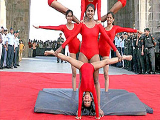 School children perform Mallakhamb at the Gateway of India in Mumbai as "Bravo" the Bison, the official mascot for the 4th Military World Games is unveiled.