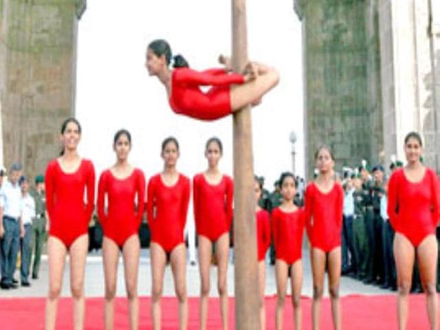 School children perform Mallakhamb at the Gateway of India in Mumbai as "Bravo" the Bison, the official mascot for the 4th Military World Games is unveiled.