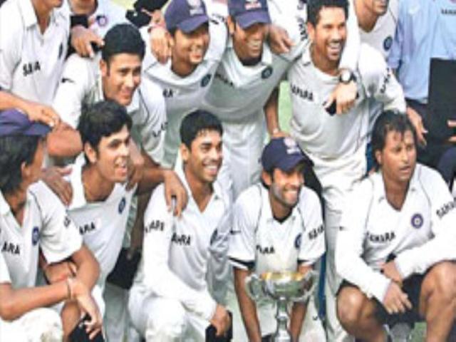 The victorious Indian team poses with their trophy after beating Bangladesh in the second Test.
