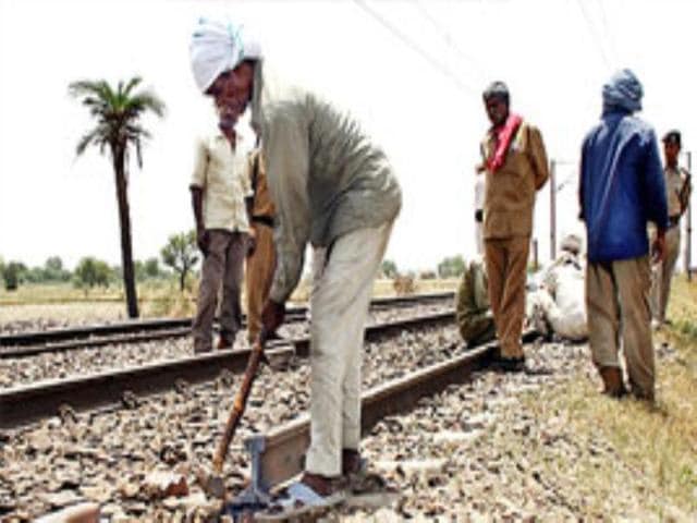 Workers repair rail tracks damaged by Gujjar mobs at Ajaibpur Railway Station near Noida.