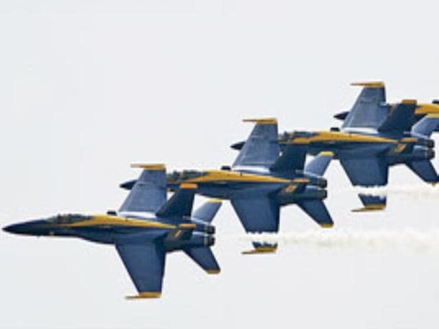 Members of the Blue Angels flight demonstration team perform at the Star Spangled Salute air show at Tinker Air Force Base, near Oklahoma.