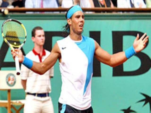 Rafael Nadal reacts after beating Roger Federer to win his third successive French Open title.