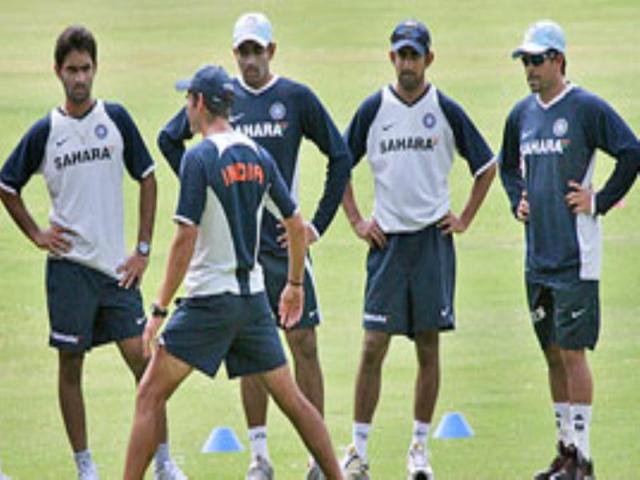 Team physical trainer gives tips to the players.