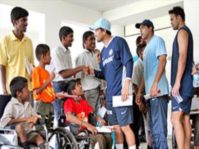 Indian cricketers meet physically challenged children in Bangalore.