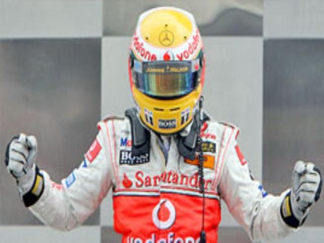McLaren's Lewis Hamilton jubilates after winning the US Grand Prix.