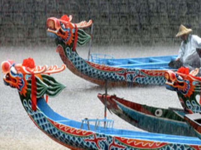 Brightly coloured long narrow wooden boats with elaborately-carved dragon heads decorate the prows in China.