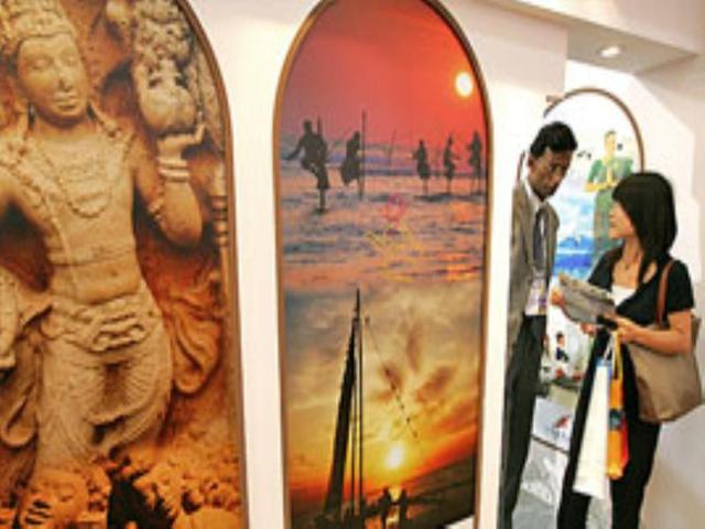 A woman inquires about travels to India on the opening day of the Beijing International Tourism Expo.
