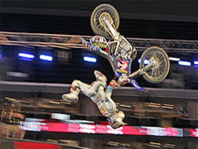 A competitor does a flip during practice for the Moto X Best Trick competition at Los Angeles.