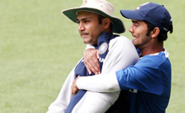 Dinesh Karthik lifts up teammate Virender Sehwag during training at the MCG in Melbourne, December 25 2007.