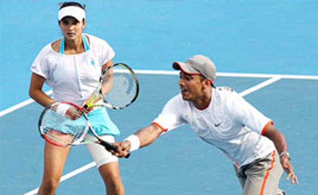 Sania Mirza watches as partner Mahesh Bhupathi plays a return during their mixed doubles semi-final match against Andy Ram and Nathalie Dechy at the Australian Open.