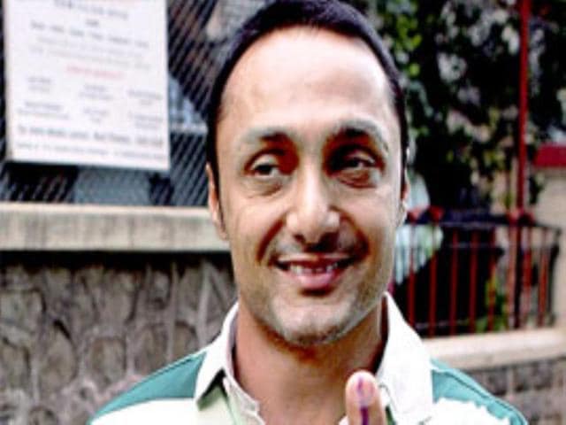 Actor Rahul Bose shows his finger marked with indelible ink after casting his vote for the state assembly elections at Bandra in Mumbai. See Full Coverage