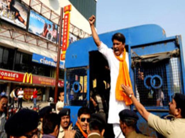 A supporter from the VHP and Bajrang Dal shouts slogans from the police van after being arrested by the police during a protest outside the City Gold Multiplex screening My Name is Khan starring Shah Rukh Khan in Ahmedabad.