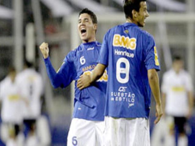 Brazil's Cruzeiro's Diego Renan celebrates with teammate Henrique after scoring against Chile's Colo Colo during a Copa Libertadores soccer match in Santiago.