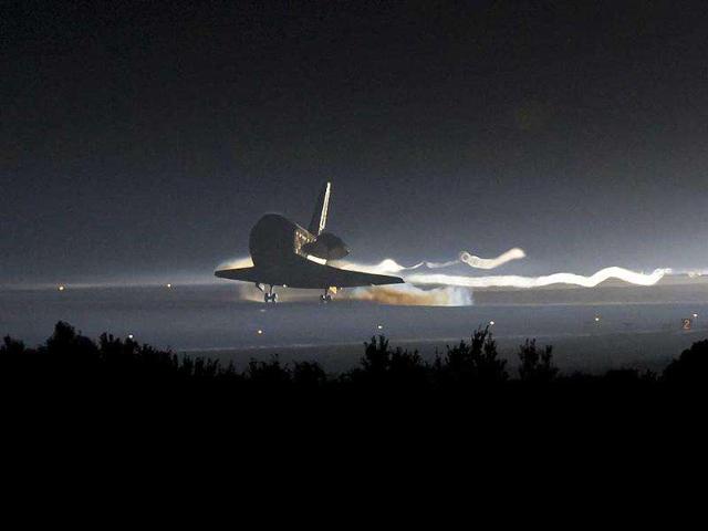 In this image provided by Nasa, Space Shuttle Atlantis touches down at Nasa's Kennedy Space Center Shuttle Landing Facility in Cape Canaveral, Florida, completing its 13-day mission to the International Space Station and the final flight of the Space Shuttle Program.