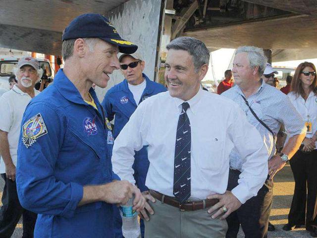 Space shuttle Atlantis mission commander Chris Ferguson speaks with Kennedy Space Center director Bob Cabana after landing at the Kennedy Space Center in Cape Canaveral, Florida.