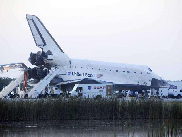 The space shuttle Atlantis is serviced after landing on runway 15 at Kennedy Space Center, Florida, completing the final shuttle mission in space.