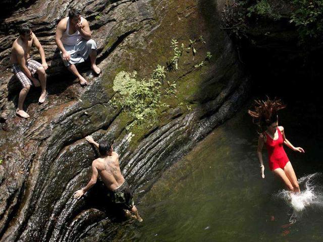 Bathers beat the midday heat at the Devil's Pool in Wissahickon Valley Park in Philadelphia.
