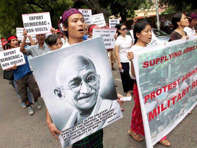 Burmese pro-democracy activists and supporters holding banners placards and participate in a protest in New Delhi.