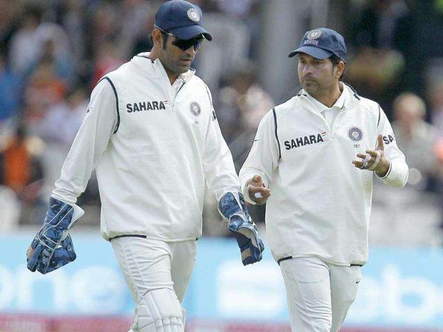 Sachin Tendulkar talks to his captain Mahendra Singh Dhoni, during the second day of the first Test against England at Lord's cricket ground in London.