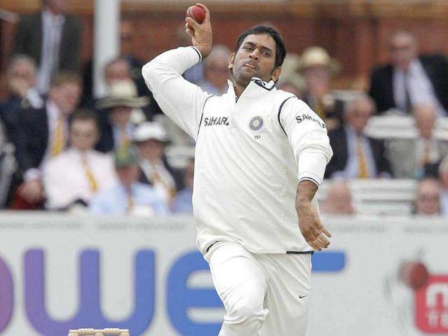 Captain and wicketkeeper MS Dhoni bowls against England during day 2 of the first Test match at Lord's cricket ground in London.