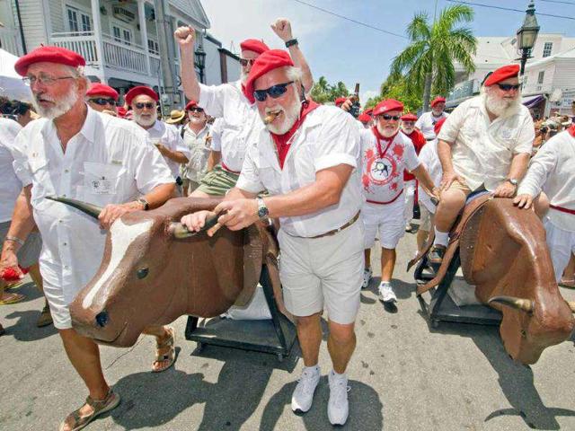 Ernest Hemingway look-alikes ride and push fake bovines during the "Running of the Bulls" in Key West, Florida. The parade was a facet of Key West's annual Hemingway Days festival set to conclude July 24.