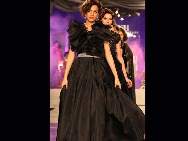 A model poses in an outfit by designer Adarsh Gill at Delhi Couture Week 2011 in New Delhi on Sunday.