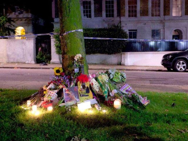 Candles and flowers are placed near a tree opposite the home of British singer Amy Winehouse in Camden Square, London, following her death.