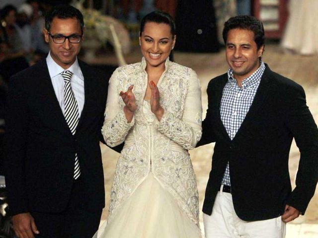 Bollywood actor Sonakshi Sinha displays a creation of designers Shantanu and Nikhil during Delhi Couture Week 2011 in New Delhi.