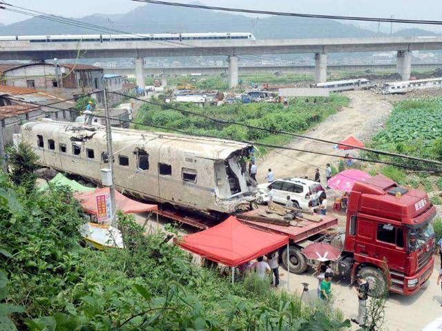 The wreckage of a high-speed train carriage is carried on a truck, two days after a fatal collision, in Shuangyu.